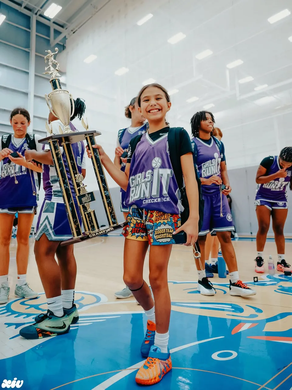 Girls Run It champion with the trophy